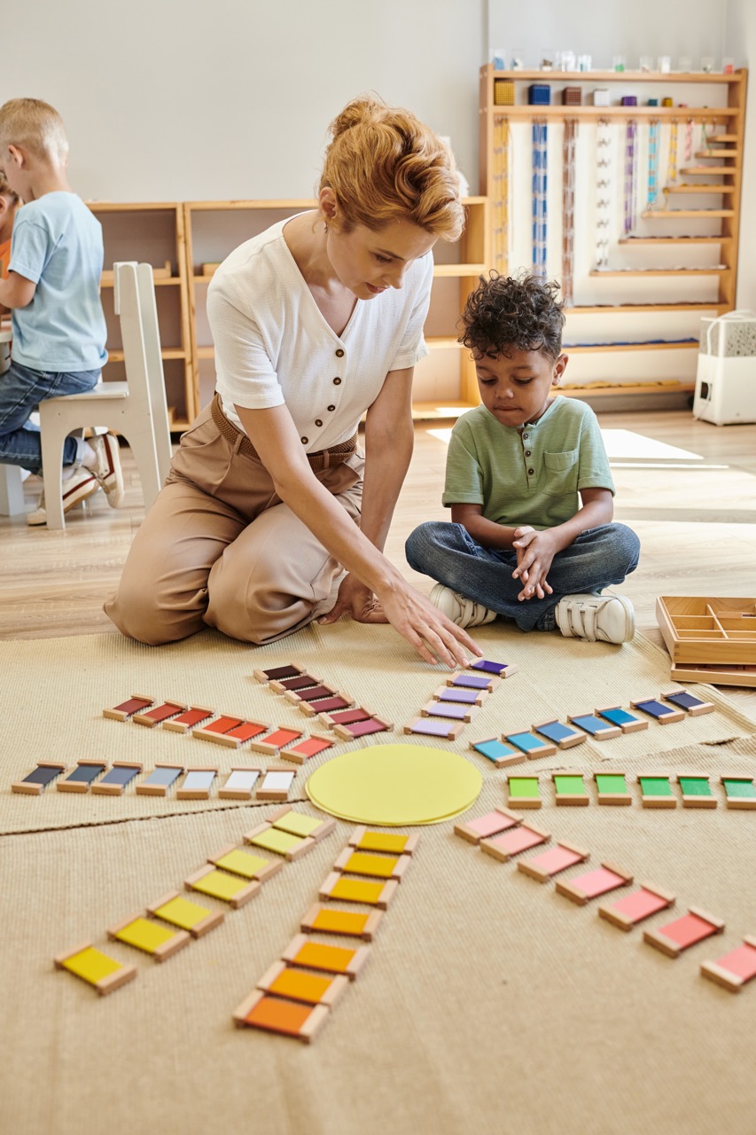 Teacher engaging with a child in a colourful Montessori classroom